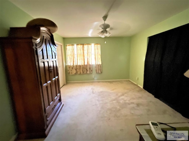 carpeted empty room with ceiling fan