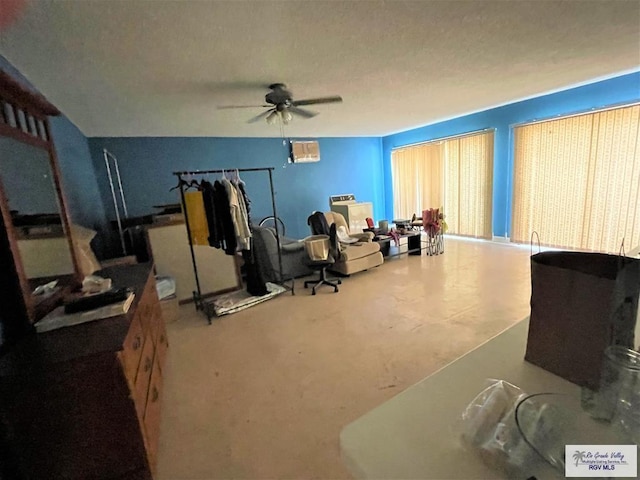 sitting room with ceiling fan and a textured ceiling