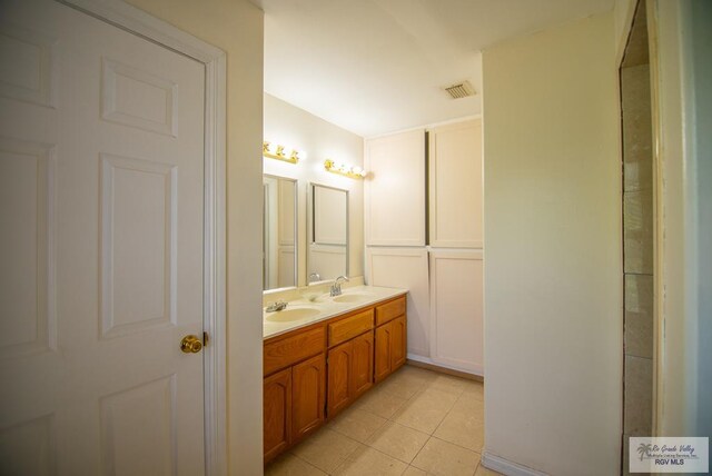3630 Sun Dr, Harlingen, TX 78552 - full bath featuring double vanity and tile patterned floors