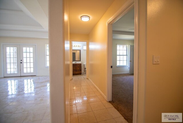 3630 Sun Dr, Harlingen, TX 78552 - corridor with light tile patterned floors, baseboards, and french doors