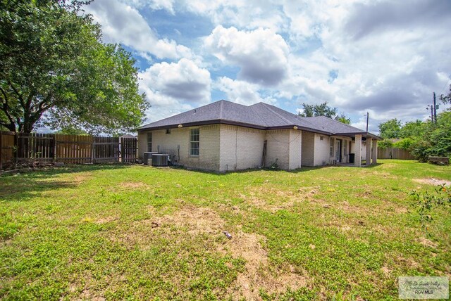 3630 Sun Dr, Harlingen, TX 78552 - rear view of property with brick siding and central AC unit
