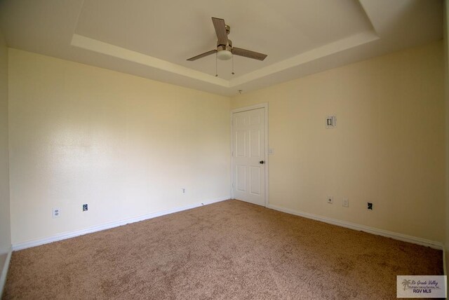 3630 Sun Dr, Harlingen, TX 78552 - carpeted empty room with a raised ceiling, ceiling fan, and baseboards