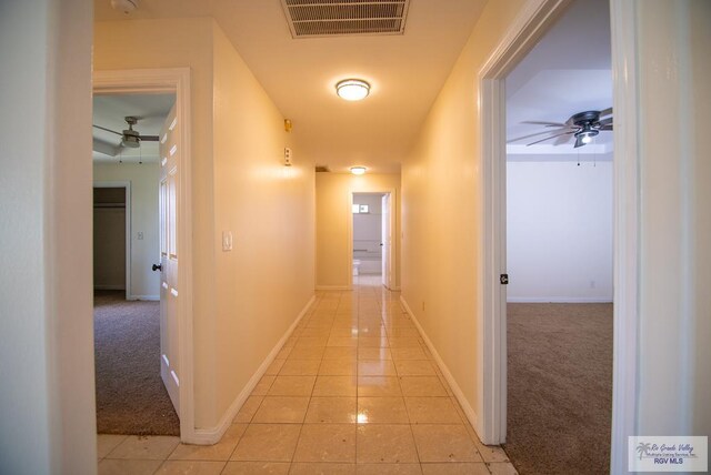 3630 Sun Dr, Harlingen, TX 78552 - corridor featuring light carpet, baseboards, and light tile patterned floors