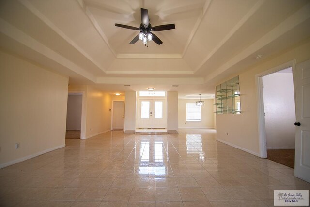 3630 Sun Dr, Harlingen, TX 78552 - spare room with a tray ceiling, a ceiling fan, and baseboards