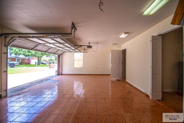 3630 Sun Dr, Harlingen, TX 78552 - garage with a garage door opener and baseboards