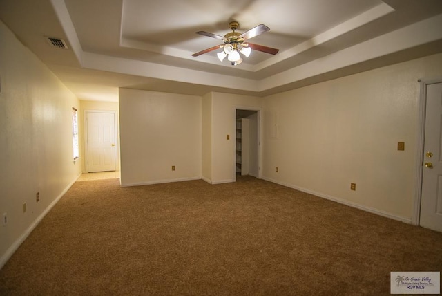 3630 Sun Dr, Harlingen, TX 78552 - unfurnished room featuring a raised ceiling, ceiling fan, carpet flooring, and baseboards