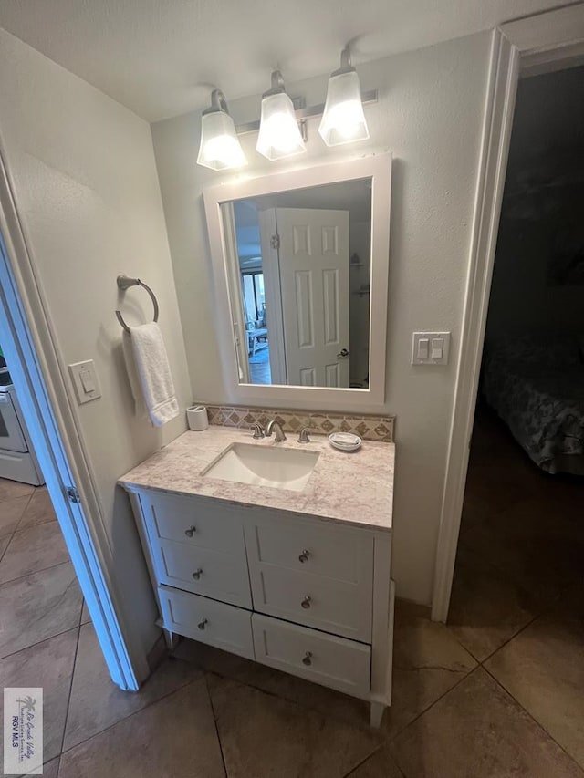 bathroom with tile patterned flooring and vanity