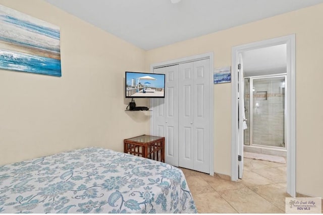 bedroom with light tile patterned floors, ensuite bathroom, and a closet