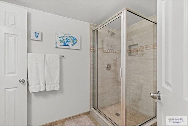 bathroom featuring a shower with shower door