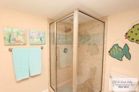 bathroom with toilet and walk in shower