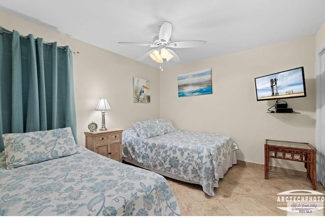 bedroom with ceiling fan and light tile patterned flooring