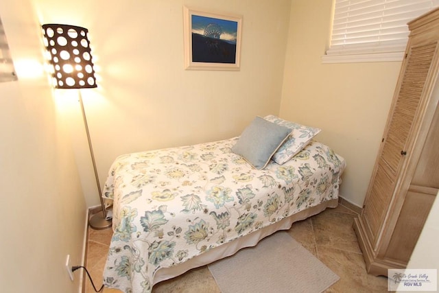 tiled bedroom with a closet