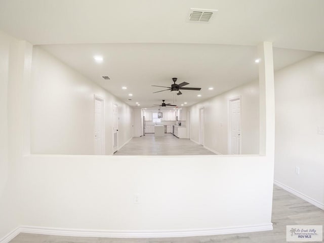 interior space with ceiling fan and light hardwood / wood-style flooring