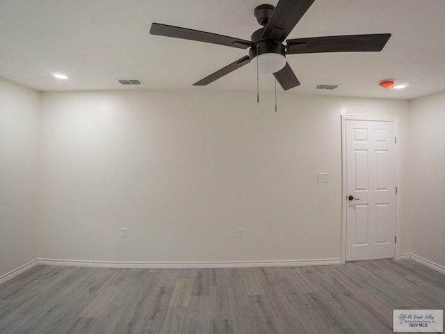 spare room with ceiling fan and light hardwood / wood-style floors