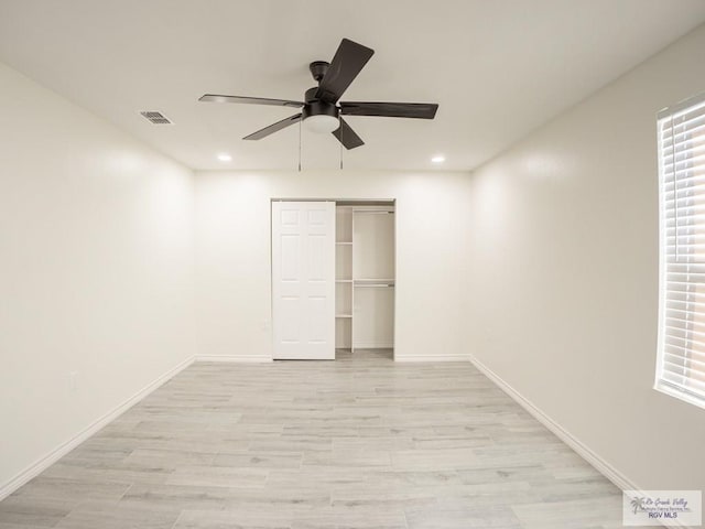 unfurnished bedroom with light hardwood / wood-style floors, a closet, and ceiling fan