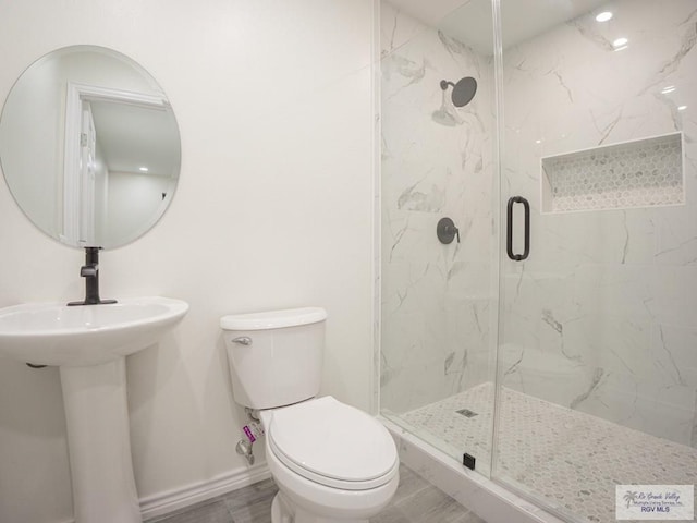 bathroom with an enclosed shower and toilet