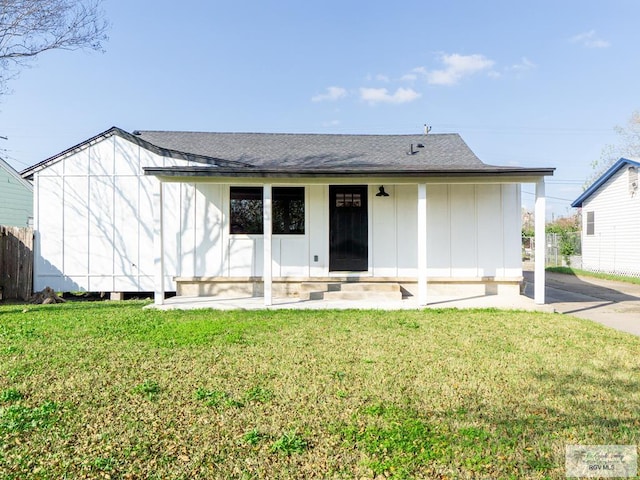 back of property featuring a lawn and a porch