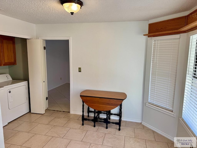 dining space featuring washer / clothes dryer, plenty of natural light, baseboards, and light tile patterned floors