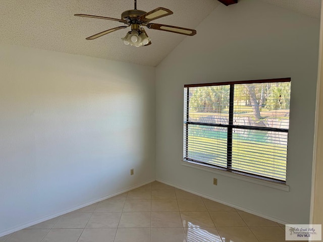 unfurnished room featuring light tile patterned floors, ceiling fan, baseboards, and vaulted ceiling