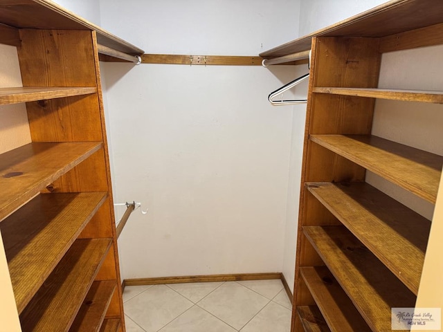 spacious closet featuring light tile patterned floors