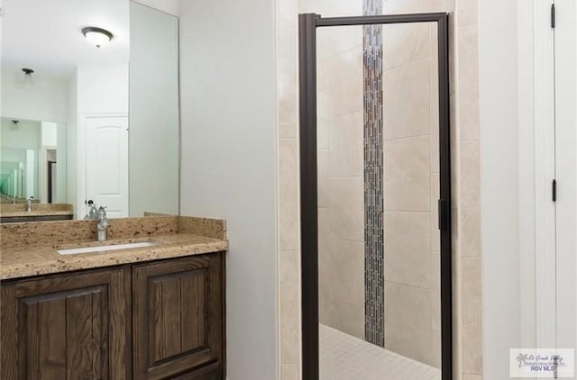 bathroom with vanity and an enclosed shower