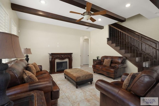 living room featuring ceiling fan and beam ceiling