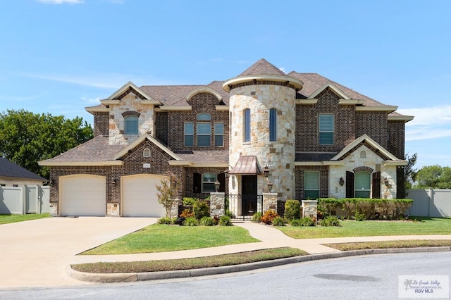 french country style house featuring a front lawn and a garage