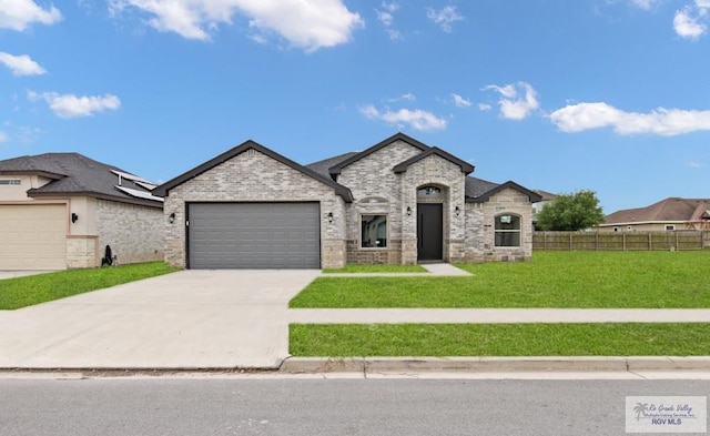 1838 Castillo St, Olmito, TX 78575 - french country inspired facade with a garage, driveway, and brick siding