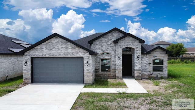 french provincial home featuring a garage