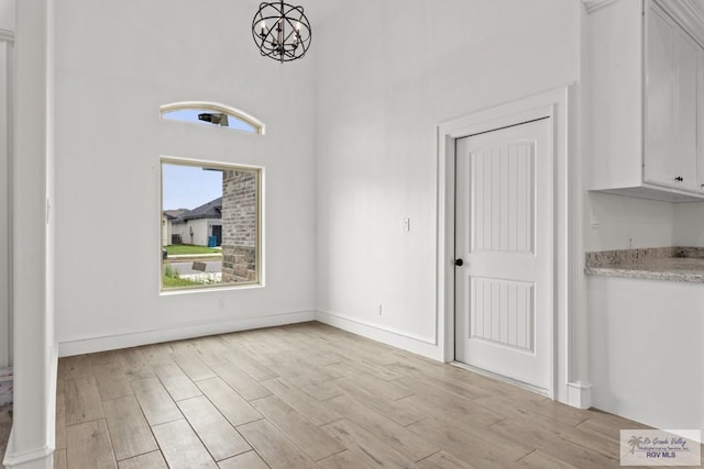 1838 Castillo St, Olmito, TX 78575 - unfurnished dining area with light wood-type flooring and a chandelier