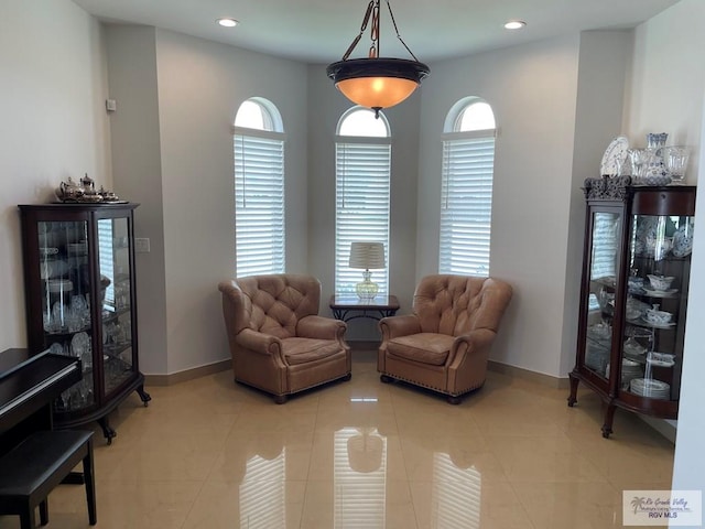 sitting room with light tile patterned floors, recessed lighting, and baseboards