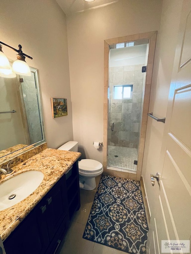 full bath with tile patterned flooring, a shower stall, toilet, and vanity