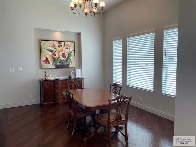 dining room featuring dark wood-style floors, baseboards, and a chandelier