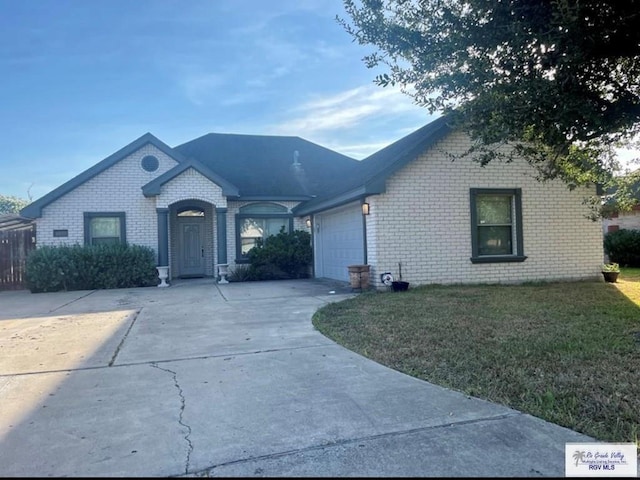 view of front of house with a garage and a front lawn