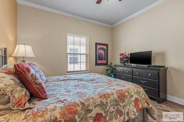 106 Atol St Unit 7, South Padre Island, TX 78597 - bedroom with ornamental molding, wood finished floors, baseboards, and a ceiling fan