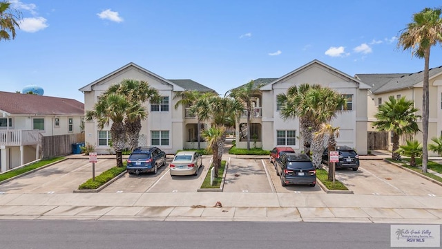 106 Atol St Unit 7, South Padre Island, TX 78597 - view of front of property with uncovered parking and stucco siding