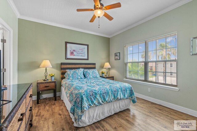 106 Atol St Unit 7, South Padre Island, TX 78597 - bedroom with wood finished floors, ornamental molding, baseboards, and ceiling fan