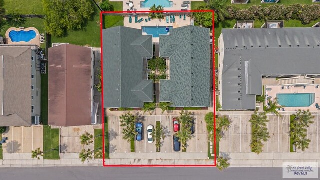 106 Atol St Unit 7, South Padre Island, TX 78597 - aerial overview of property's location featuring a pool area and property boundaries highlighted
