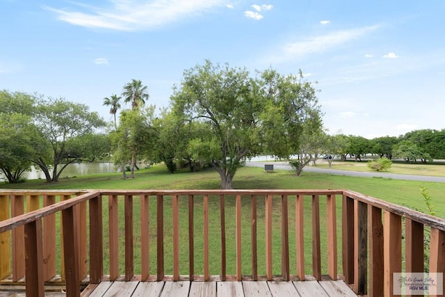 deck featuring a lawn and a water view