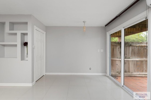 empty room with light tile patterned floors