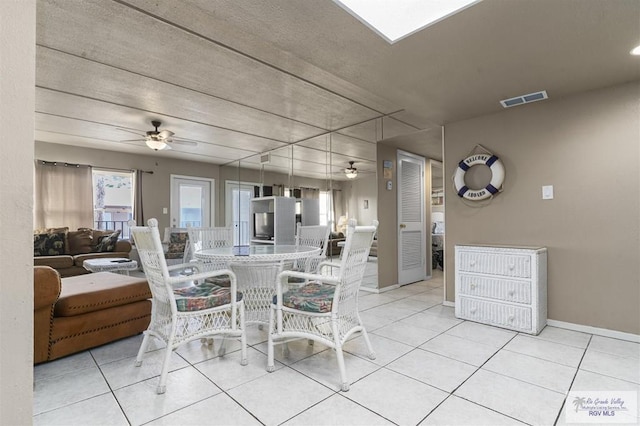 tiled dining room with ceiling fan