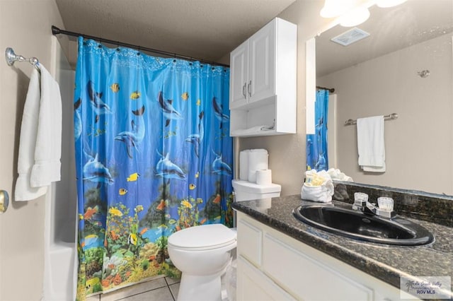 bathroom with tile patterned floors, vanity, and toilet