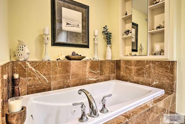 bathroom with a relaxing tiled tub and built in shelves