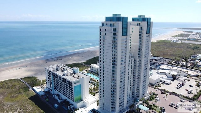 drone / aerial view featuring a water view and a view of the beach