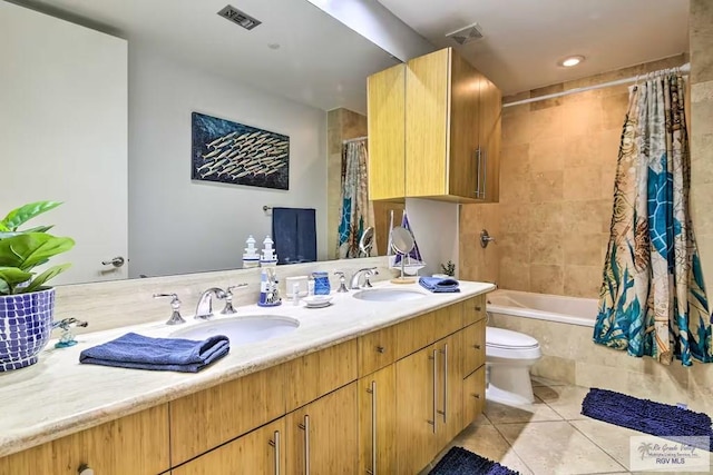 full bathroom featuring toilet, tile patterned flooring, vanity, and shower / bath combo with shower curtain