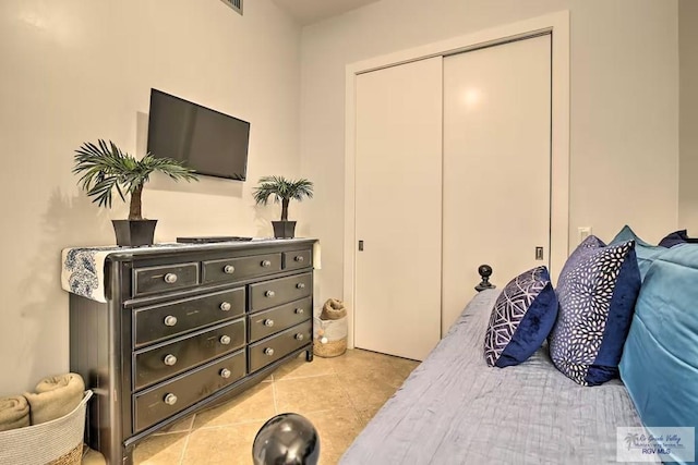 tiled bedroom with a closet