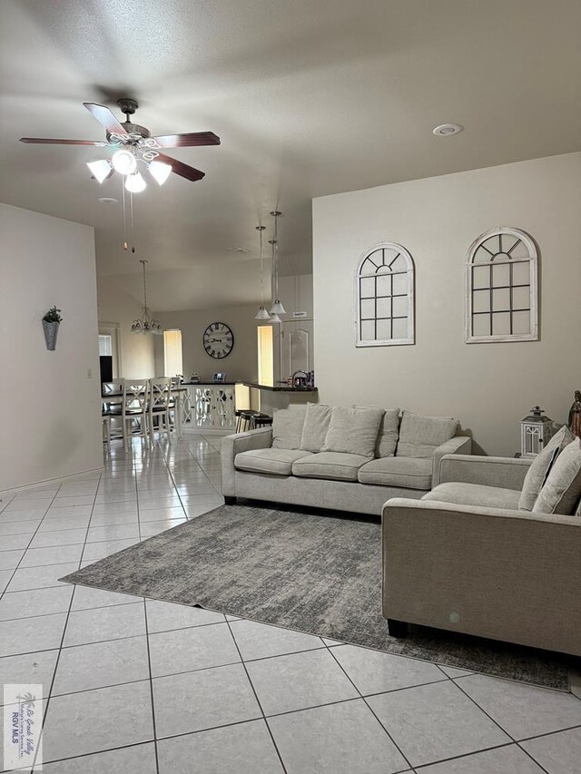 tiled dining space featuring vaulted ceiling and an inviting chandelier