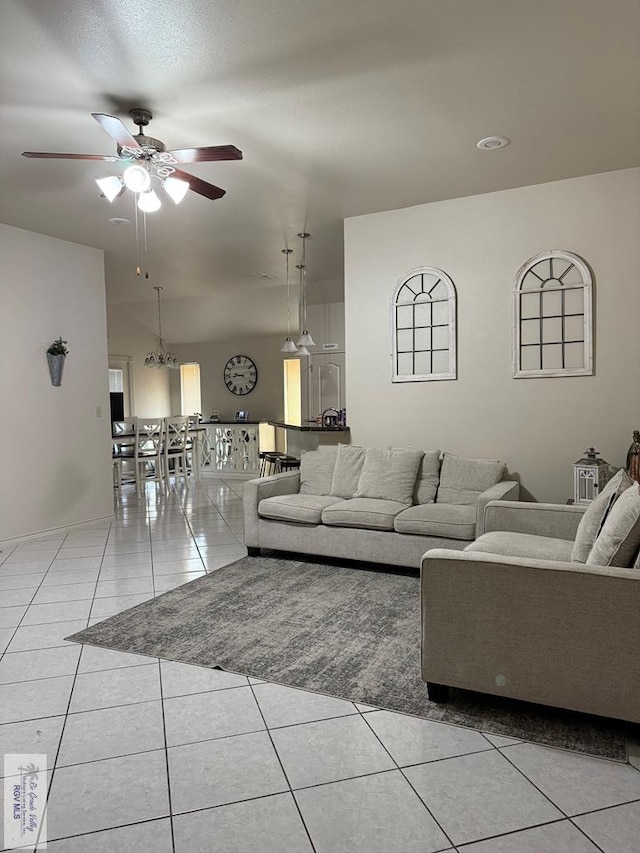 living room featuring light tile patterned floors and ceiling fan