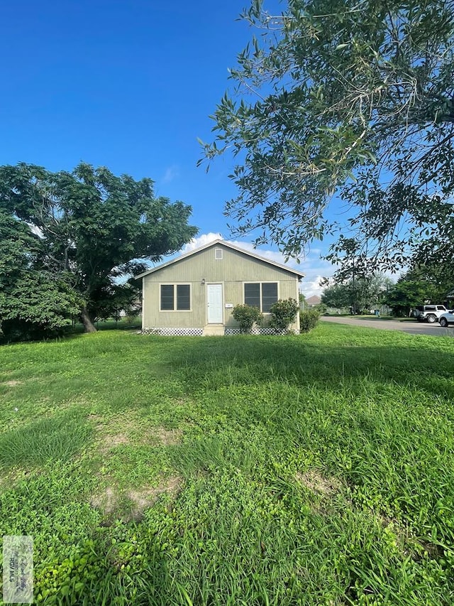 view of side of property with a lawn