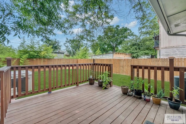 wooden terrace featuring a lawn